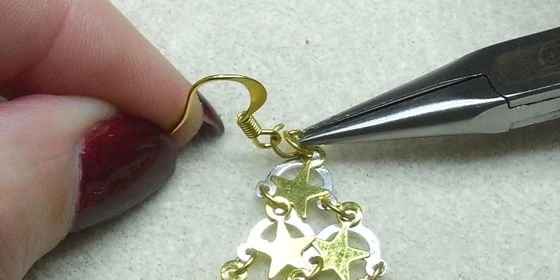Attach an earring wire to the stars with a jump ring Attach an earring wire to the stars with a jump ring