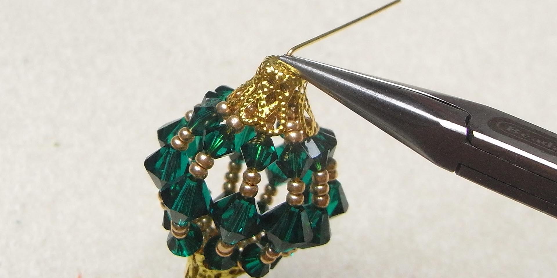 bend head pin sideways above bead cap