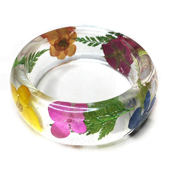 Clear resin bangle filled with colourful flowers and greenery