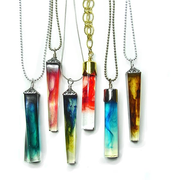 Skinny crystal-shaped resin pendants coloured with swirls of whispy colour through the resin.