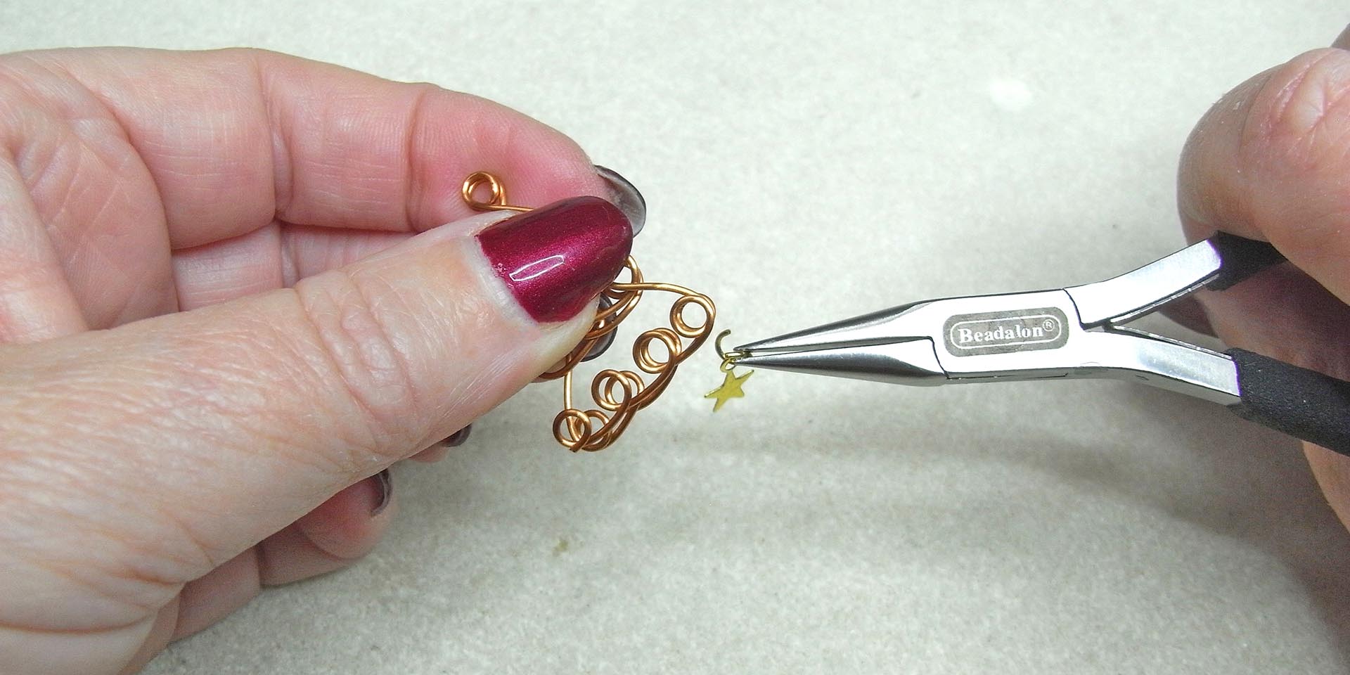 Hook star onto the bottom loop with a jump ring Hook star onto the bottom loop with a jump ring