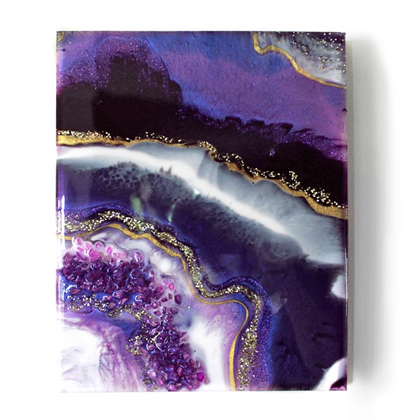 Geode-inspired resin painting in shades of purple, featuring veins of gold